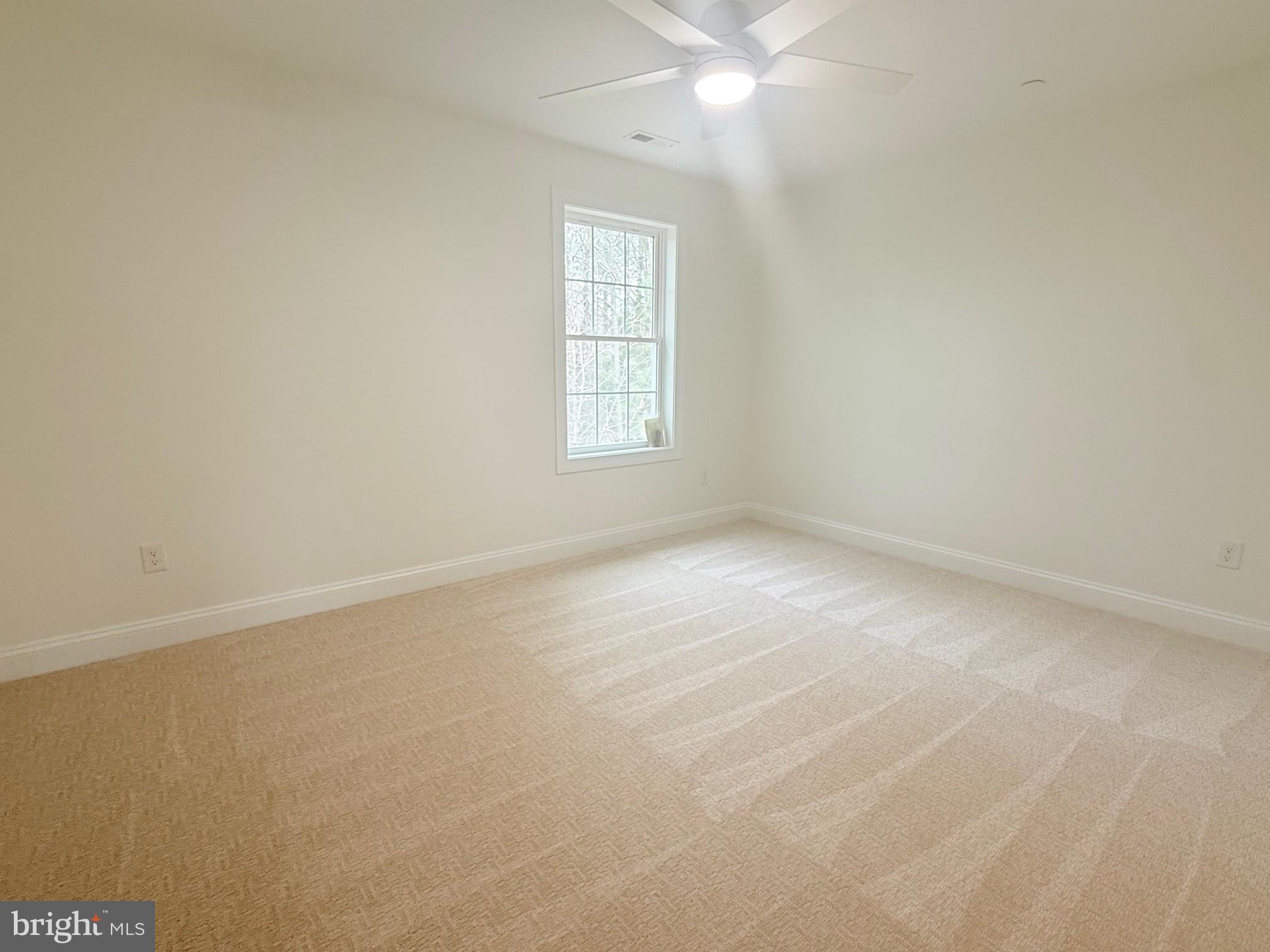17490 Lighthouse Commons Drive Piney Point, MD 20674 - Photo 37 of 44 an empty room with a window and a fan