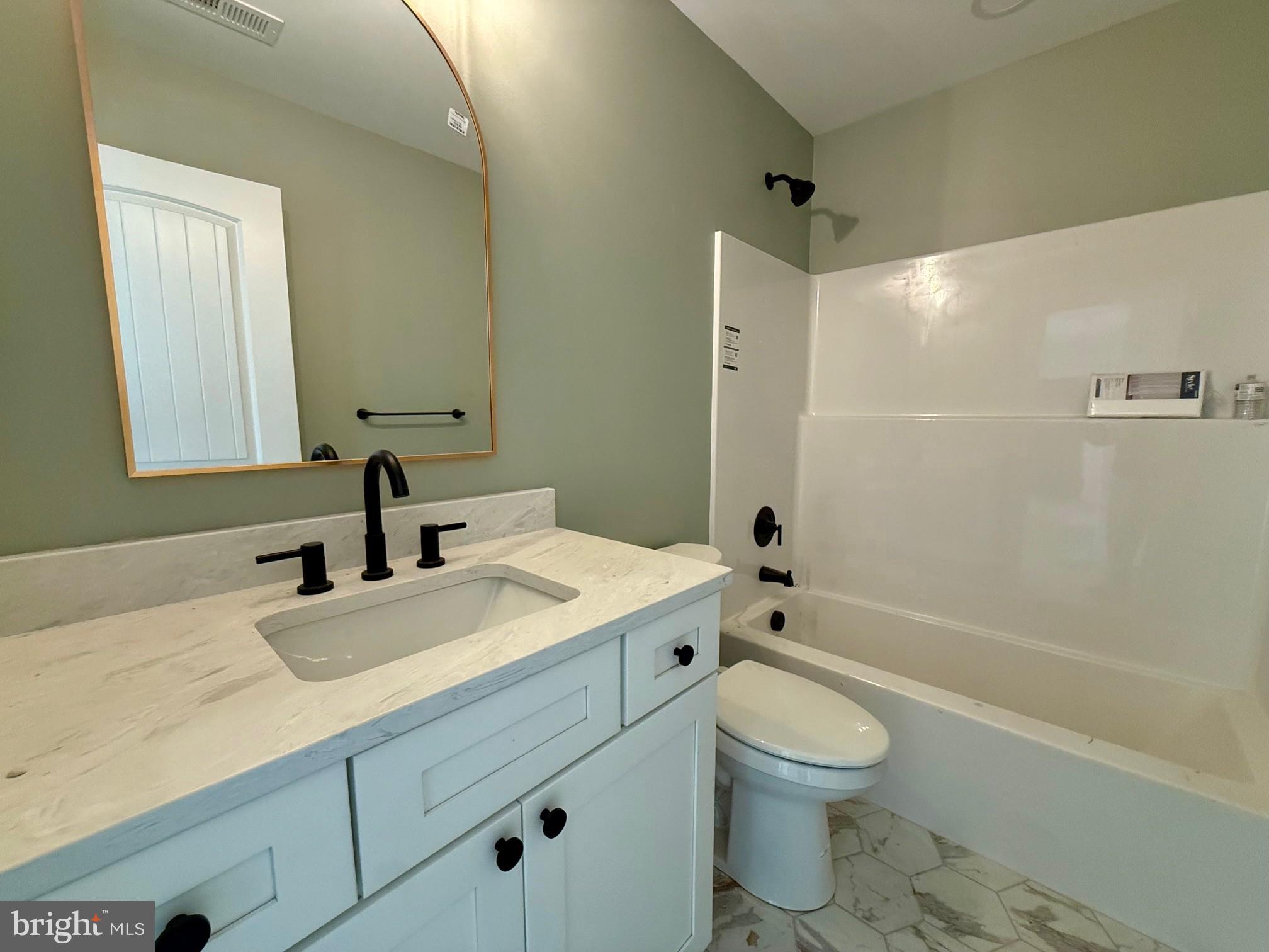 17490 Lighthouse Commons Drive Piney Point, MD 20674 - Photo 39 of 44 a bathroom with a granite countertop sink a toilet and shower