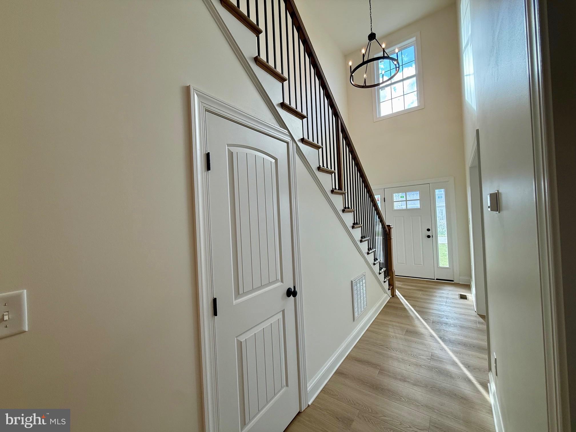 17490 Lighthouse Commons Drive Piney Point, MD 20674 - Photo 4 of 44 a view of a hallway with wooden floor and stairs