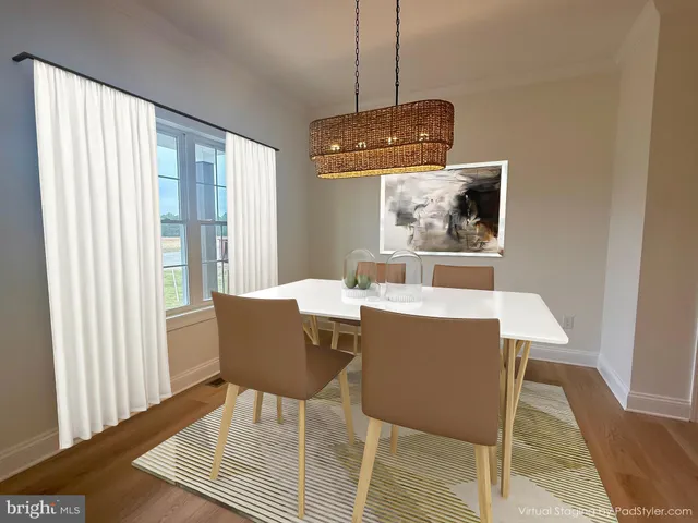 a dining room with wooden floor and a chandelier