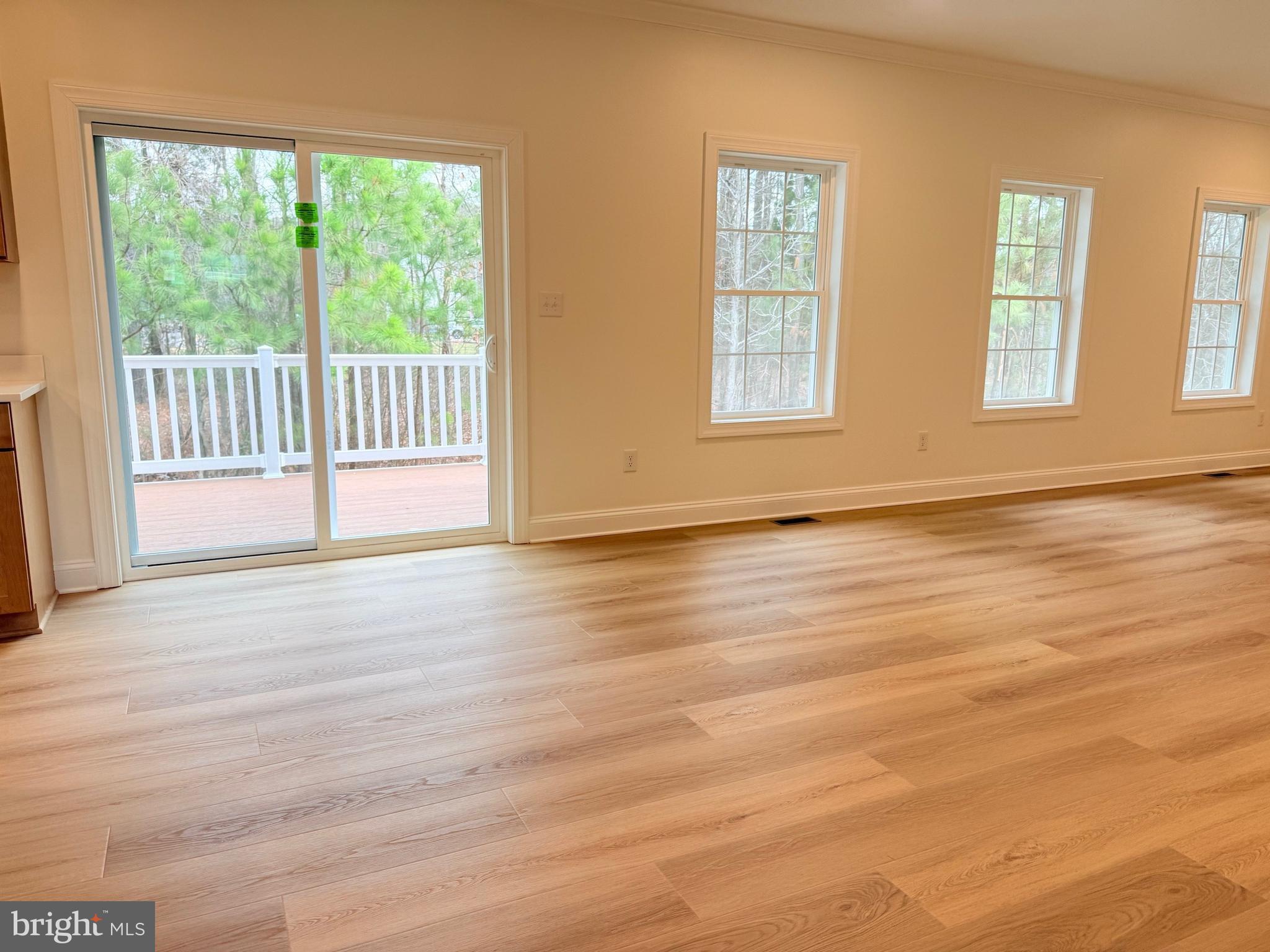 17490 Lighthouse Commons Drive Piney Point, MD 20674 - Photo 8 of 44 a view of an empty room with wooden floor and a window