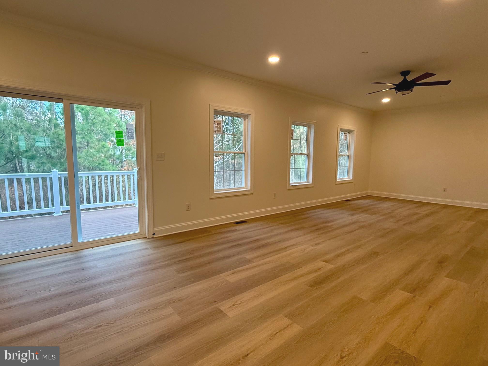 17490 Lighthouse Commons Drive Piney Point, MD 20674 - Photo 9 of 44 a view of an empty room with wooden floor and a window