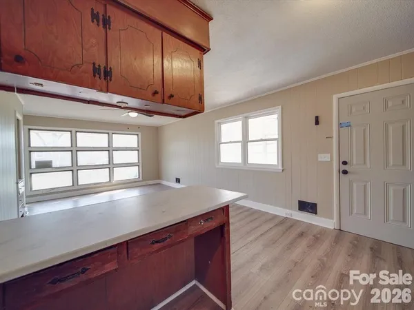 a view of a kitchen cabinets a sink and wooden floor