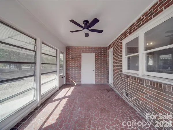 a view of a house with a window and a ceiling fan