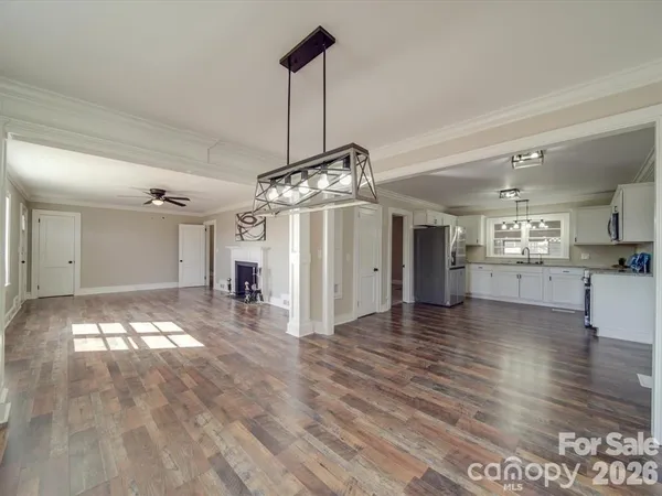 a view of a room with wooden floor