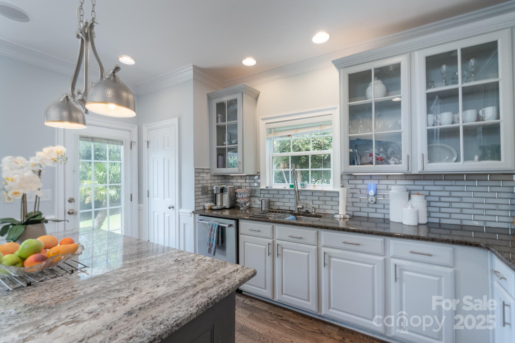 779 Fairway Point Drive Tega Cay, SC 29708 - Photo 11 of 48 a kitchen with granite countertop a stove a sink and dishwasher