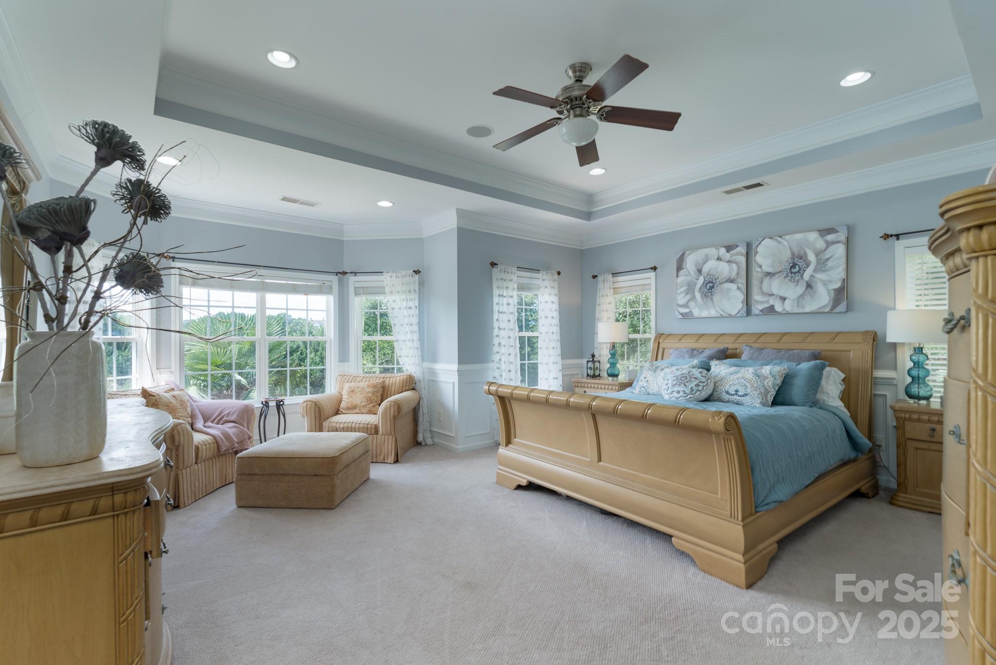 779 Fairway Point Drive Tega Cay, SC 29708 - Photo 21 of 48 a spacious bedroom with a bed and a large window