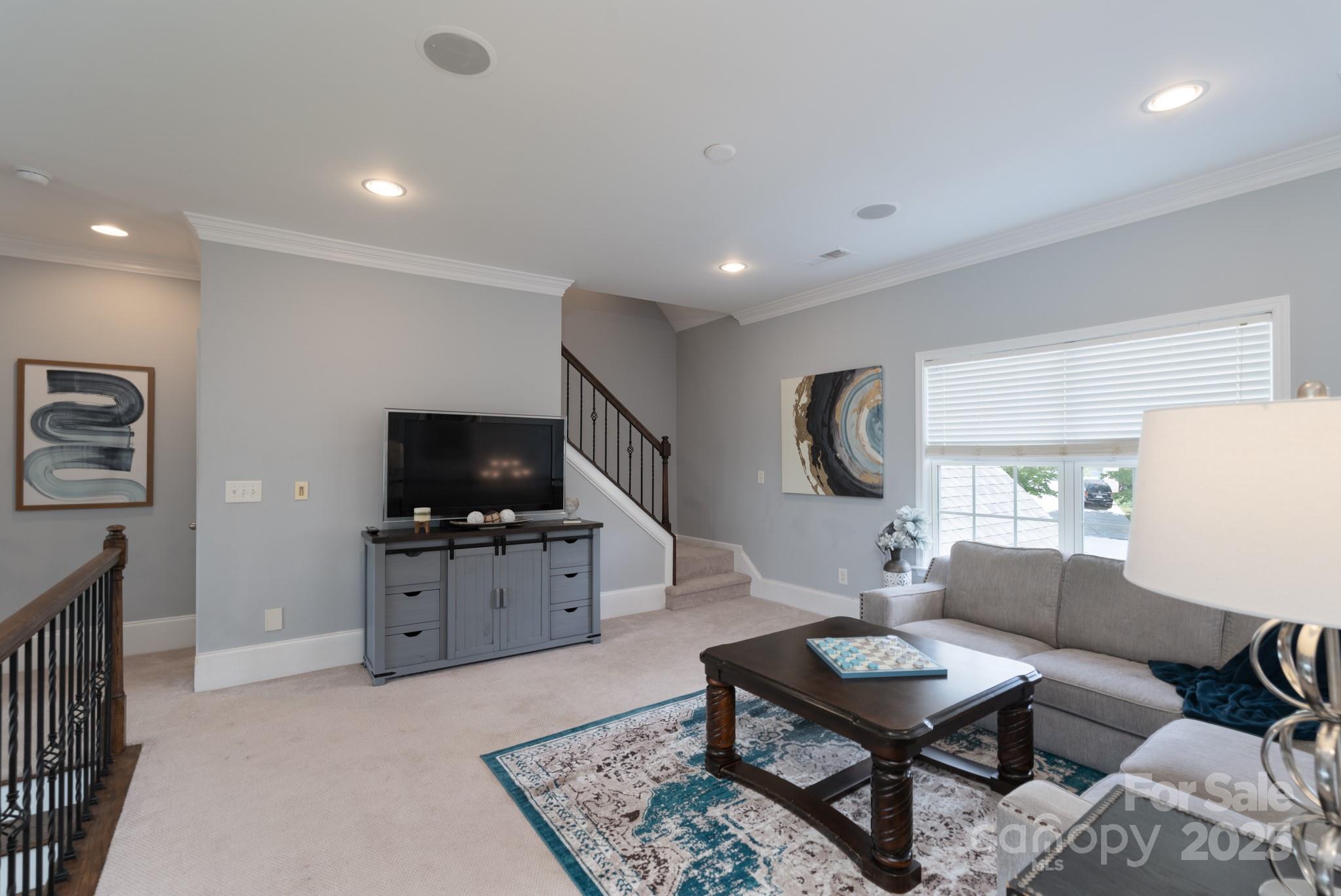 779 Fairway Point Drive Tega Cay, SC 29708 - Photo 29 of 48 a living room with furniture and a flat screen tv
