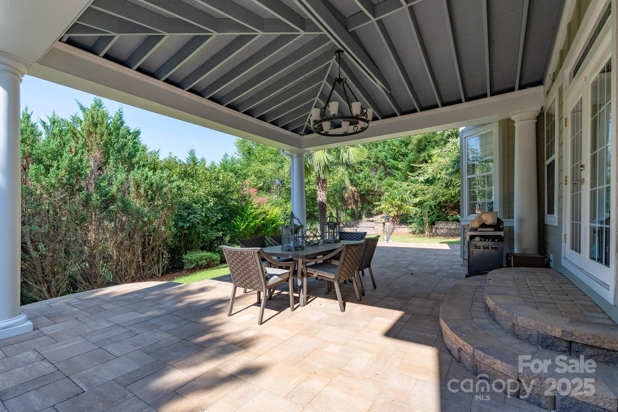 779 Fairway Point Drive Tega Cay, SC 29708 - Photo 35 of 48 a view of a patio with a table chairs and a backyard