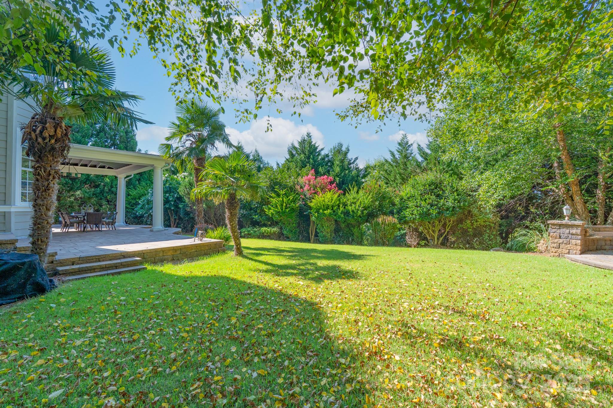 779 Fairway Point Drive Tega Cay, SC 29708 - Photo 43 of 48 a view of a backyard with a garden and swimming pool