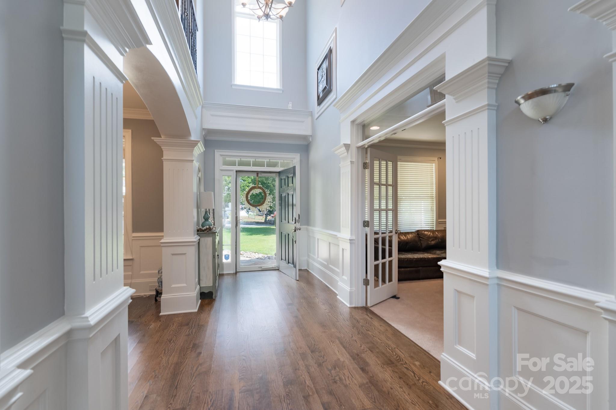 779 Fairway Point Drive Tega Cay, SC 29708 - Photo 5 of 48 a hallway with wooden floor fireplace and windows