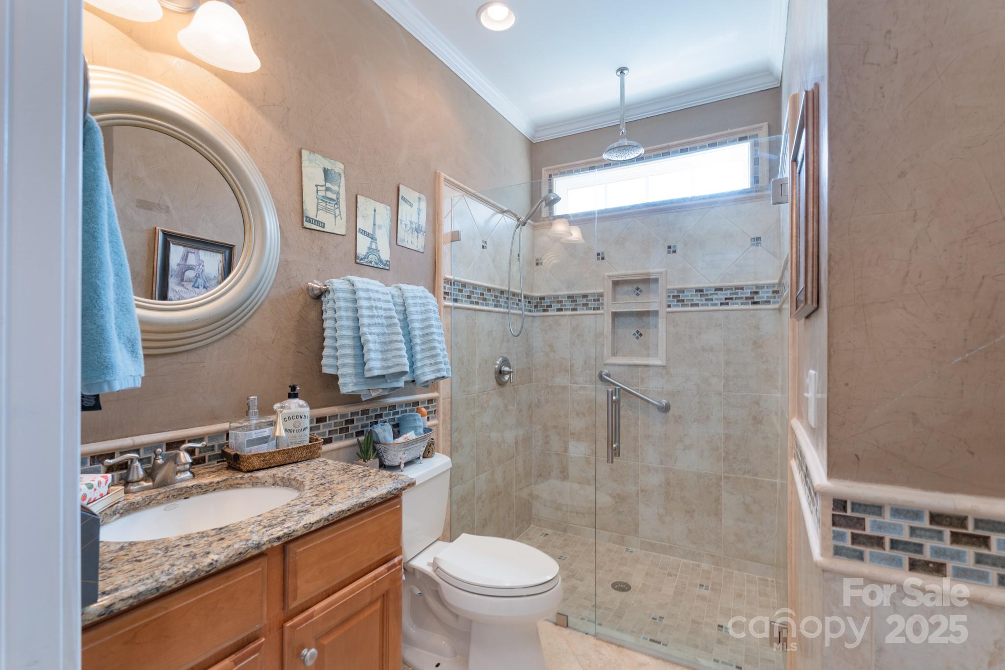 779 Fairway Point Drive Tega Cay, SC 29708 - Photo 9 of 48 a bathroom with a granite countertop sink toilet mirror vanity and shower