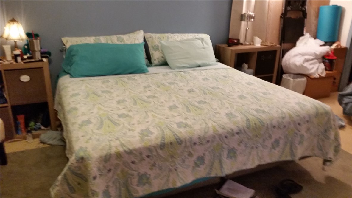 12212 County Road 1336 Sinton, TX 78387 - Photo 2 of 15 a large bed sitting in a bedroom next to a window