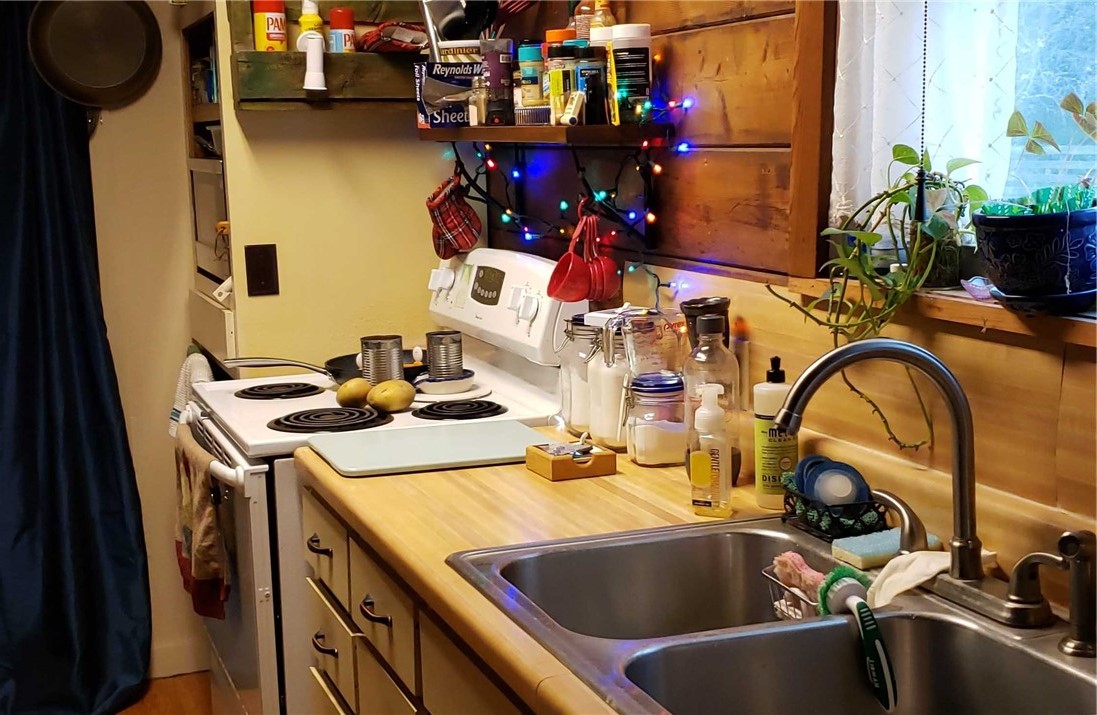 12212 County Road 1336 Sinton, TX 78387 - Photo 6 of 15 a kitchen with a sink and a stove top oven