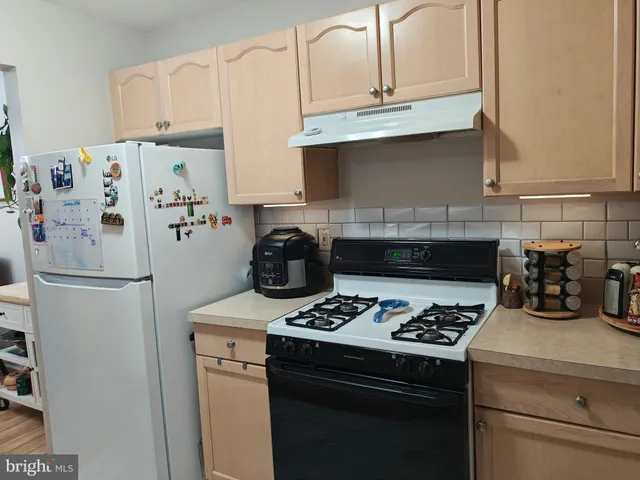 a kitchen with a stove and a refrigerator
