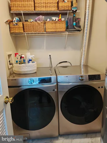 a utility room with sink dryer and washer