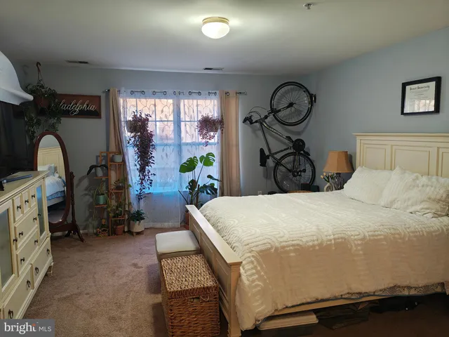 a bed sitting in a bedroom next to a window