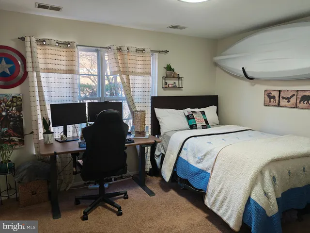 a bedroom with a bed and a desk