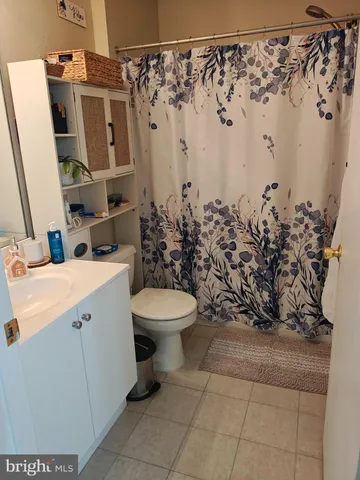 a bathroom with a toilet sink and shower