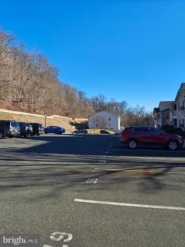 a view of city street with a car parked in front of it
