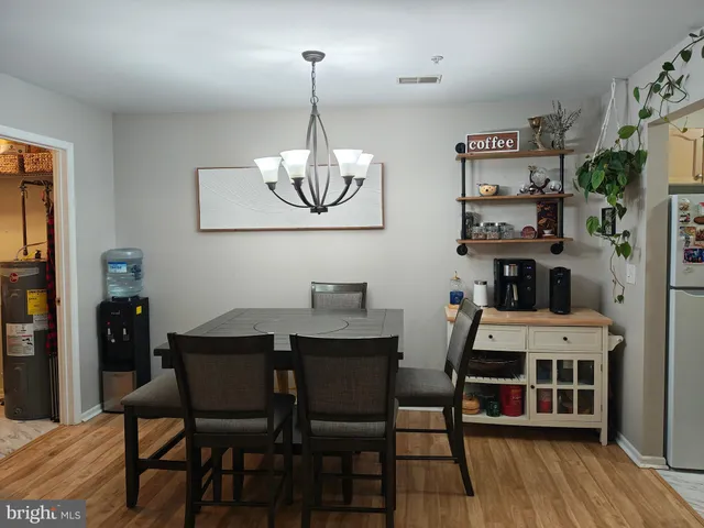 a view of a dining room with furniture wooden floor and chandelier