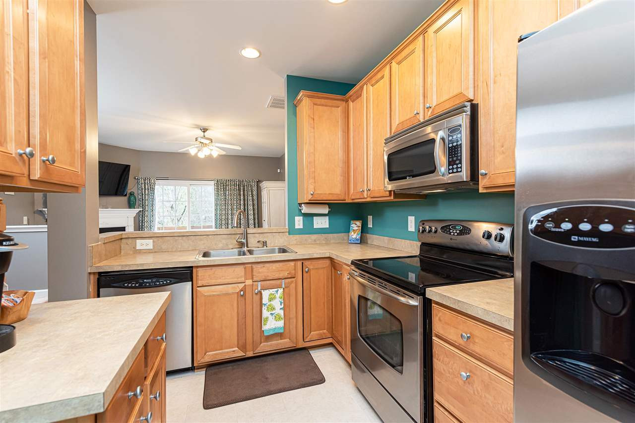 7749 Winners Edge Street Raleigh, NC 27617 - Photo 4 of 29 Kitchen features stainless steel appliances, lots of counter space, lazy susan corner cabinet, and self cleaning oven. Kitchen