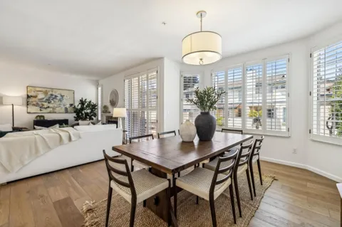 a view of a dining room with furniture wooden floor and chandelier