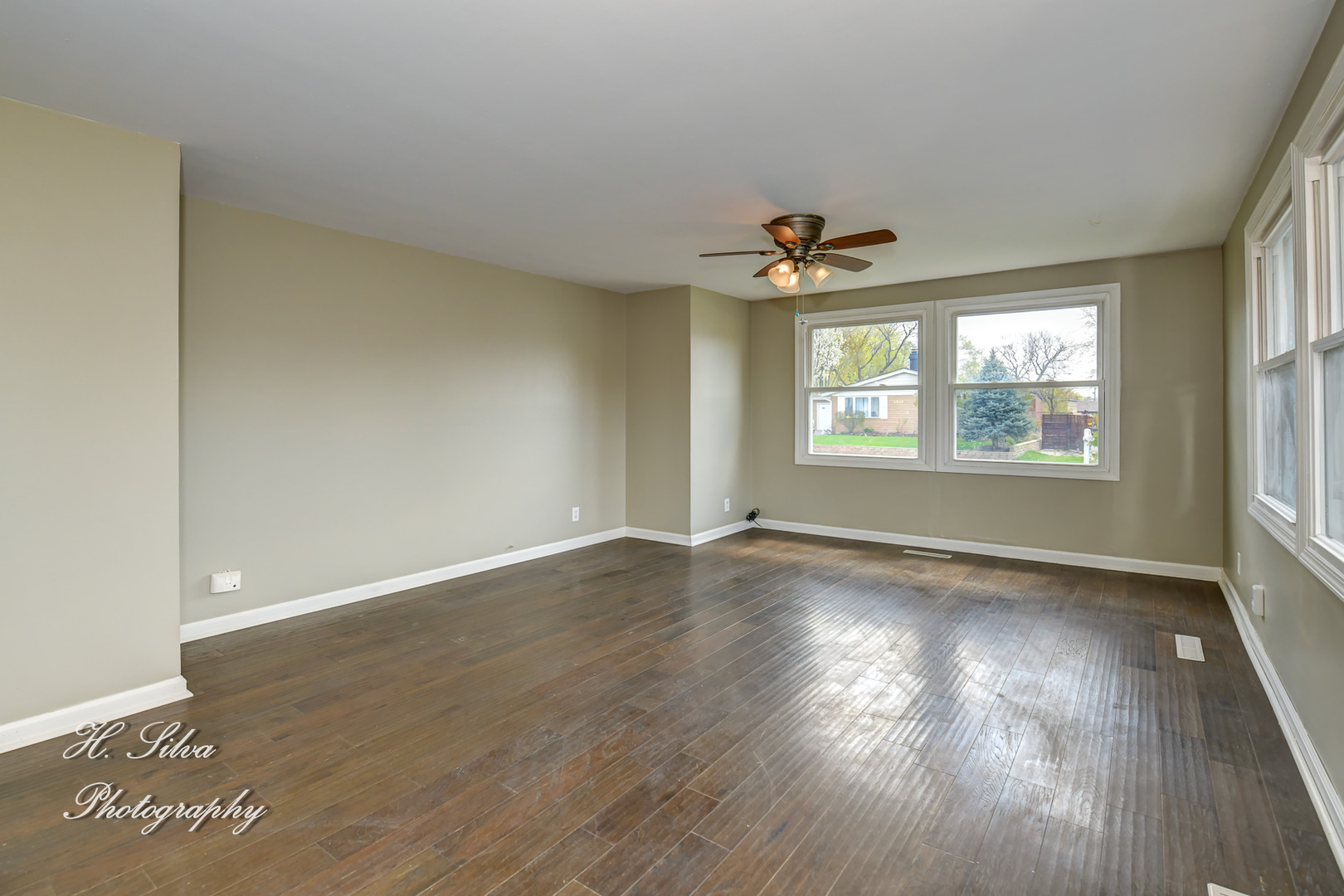 1516 Pawnee Road Carpentersville, IL 60110 - Photo 3 of 12 an empty room with wooden floor and windows