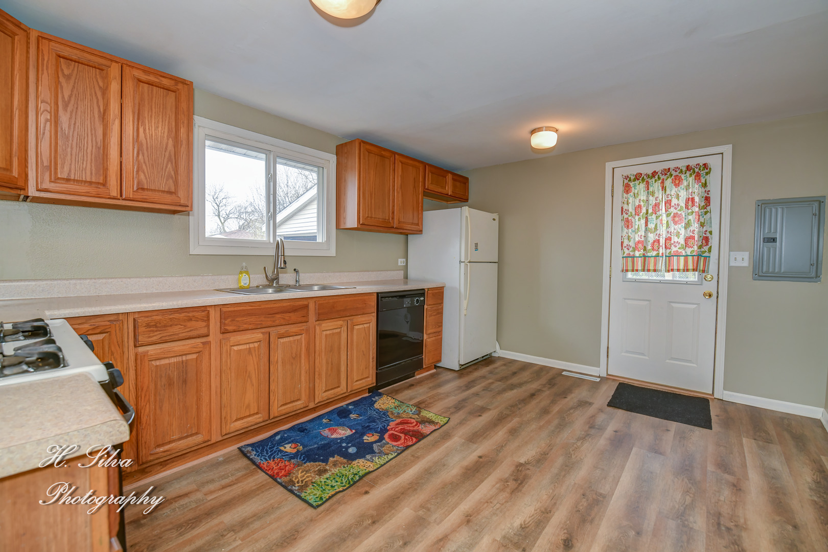 1516 Pawnee Road Carpentersville, IL 60110 - Photo 4 of 12 a kitchen with granite countertop a sink cabinets and window