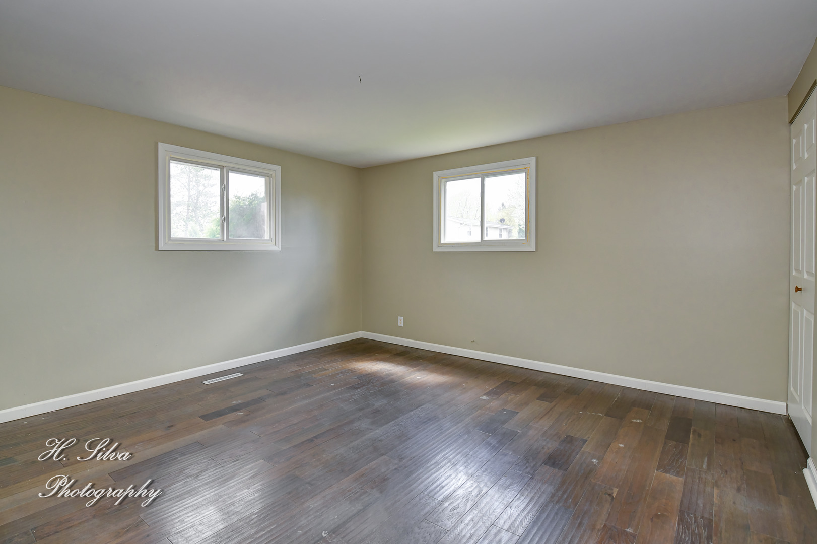 1516 Pawnee Road Carpentersville, IL 60110 - Photo 6 of 12 a view of an empty room with wooden floor and a window