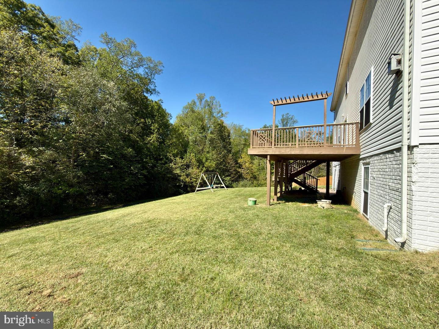 83 Ripley Road Stafford, VA 22556 - Photo 41 of 41 Spacious backyard with a serene deck view.