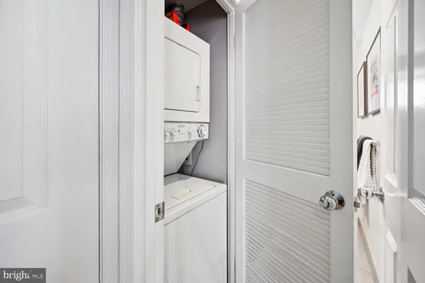 a white bath tub sitting next to a white cabinet
