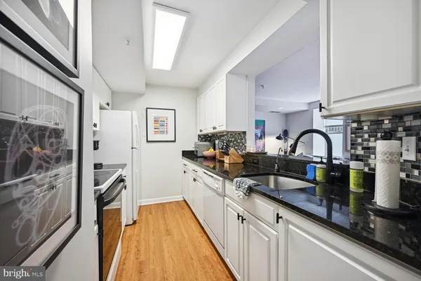 a view of a kitchen with a sink and cabinets