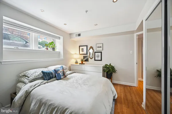 a bedroom with a bed and a potted plant