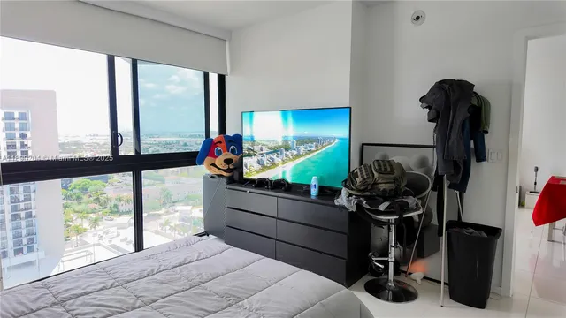 a bedroom with furniture and large windows