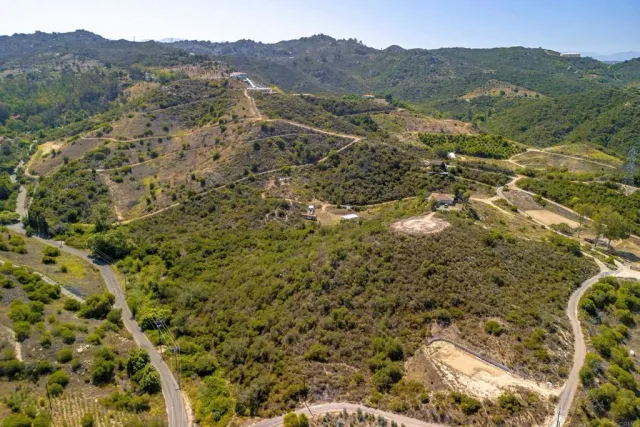 a view of a lush green hillside and a building
