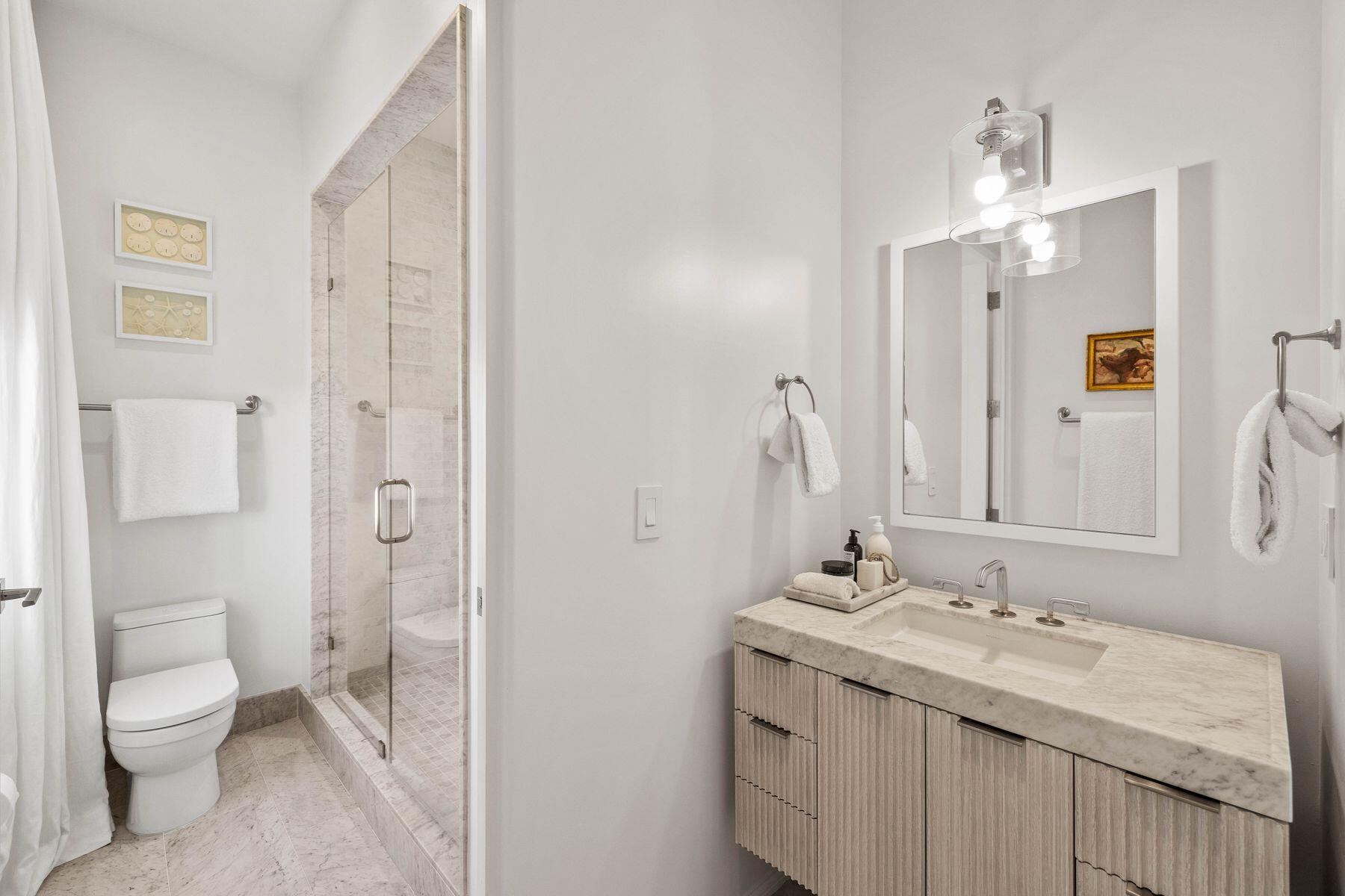 74 Kaiya Ave Inlet Beach Inlet Beach, FL 32461 - Photo 26 of 49 a bathroom with a granite countertop toilet a sink and a mirror