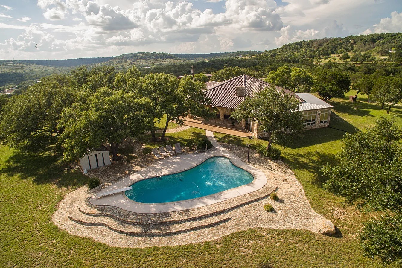 9763 Ranch Road 1623 Blanco, TX 78606 - Photo 1 of 40 a view of a house with a yard