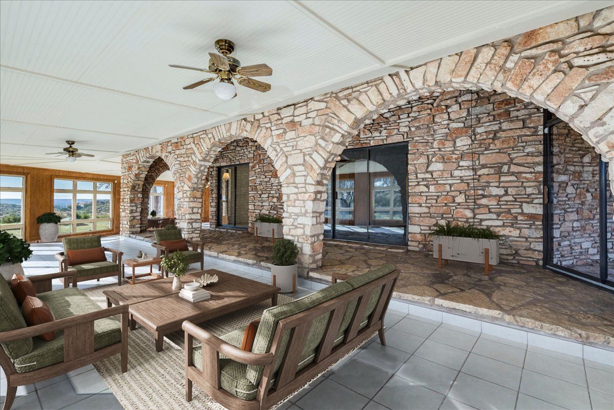 9763 Ranch Road 1623 Blanco, TX 78606 - Photo 16 of 40 a living room with couches a fireplace and a dining table with garden view