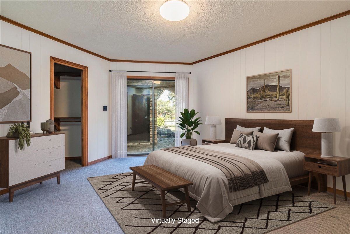 9763 Ranch Road 1623 Blanco, TX 78606 - Photo 19 of 40 a bedroom with a large bed and a chandelier