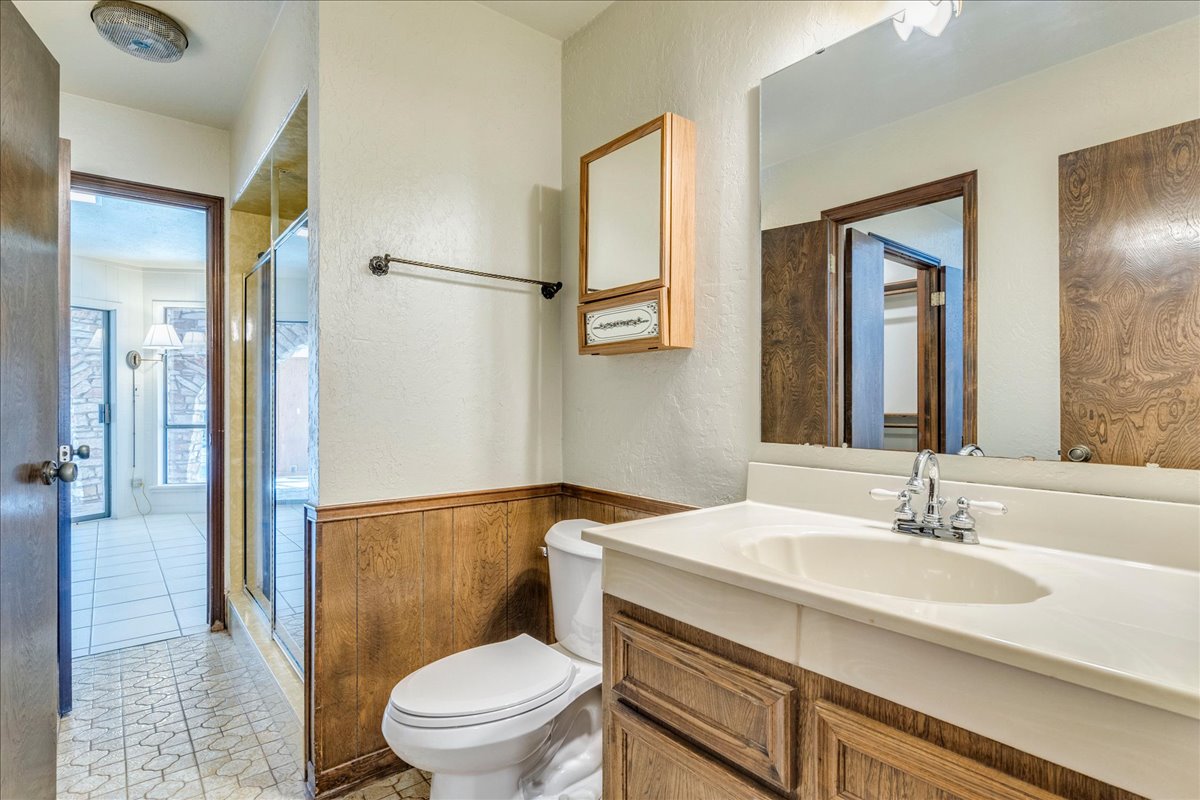 9763 Ranch Road 1623 Blanco, TX 78606 - Photo 20 of 40 a bathroom with a sink a toilet and shower