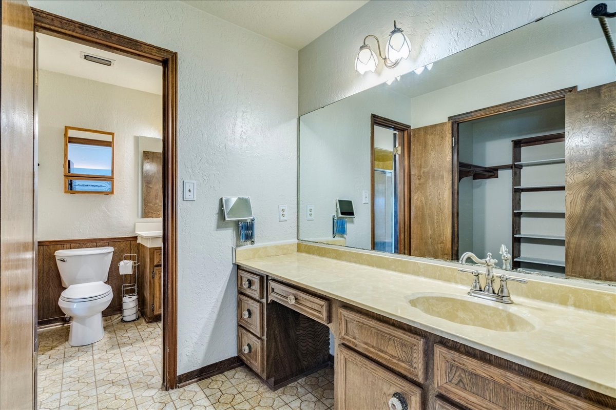 9763 Ranch Road 1623 Blanco, TX 78606 - Photo 22 of 40 a bathroom with a sink double vanity and a toilet