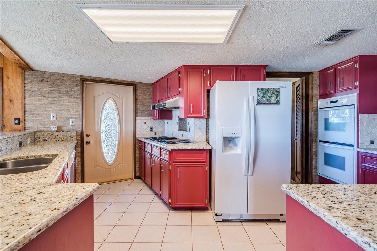 9763 Ranch Road 1623 Blanco, TX 78606 - Photo 28 of 40 a kitchen with stainless steel appliances granite countertop a refrigerator and a sink