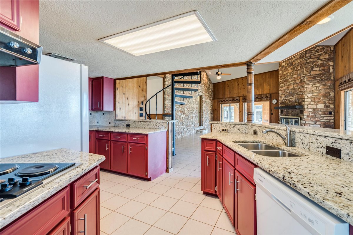 9763 Ranch Road 1623 Blanco, TX 78606 - Photo 29 of 40 a kitchen with stainless steel appliances granite countertop a sink stove and cabinets