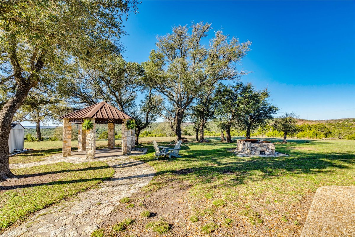 9763 Ranch Road 1623 Blanco, TX 78606 - Photo 34 of 40 a view of a house with a yard