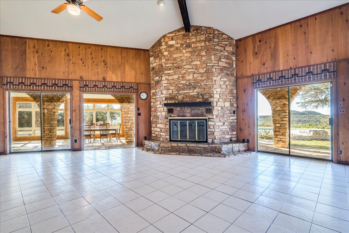 9763 Ranch Road 1623 Blanco, TX 78606 - Photo 10 of 40 Spacious living area featuring a prominent floor-to-ceiling stone fireplace