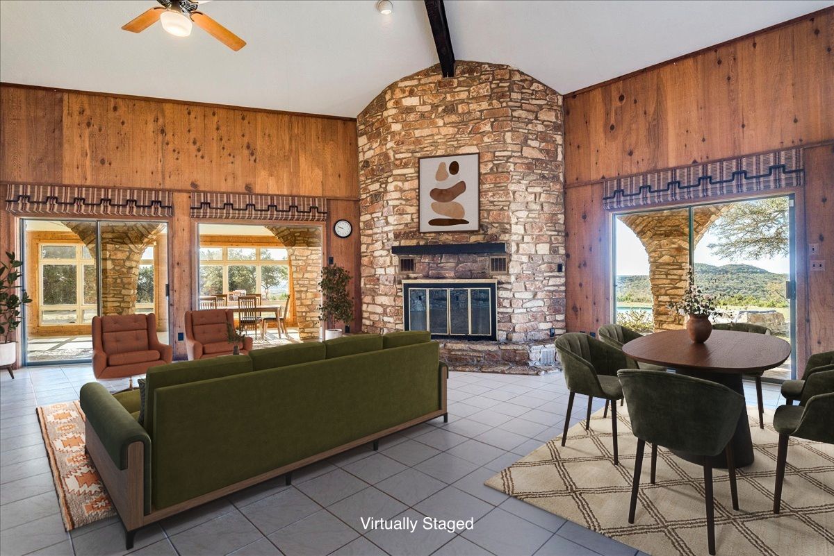 9763 Ranch Road 1623 Blanco, TX 78606 - Photo 10 of 40 a living room with furniture a fireplace and a chandelier