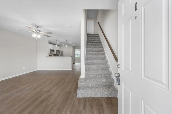 a view of entryway and hall with wooden floor