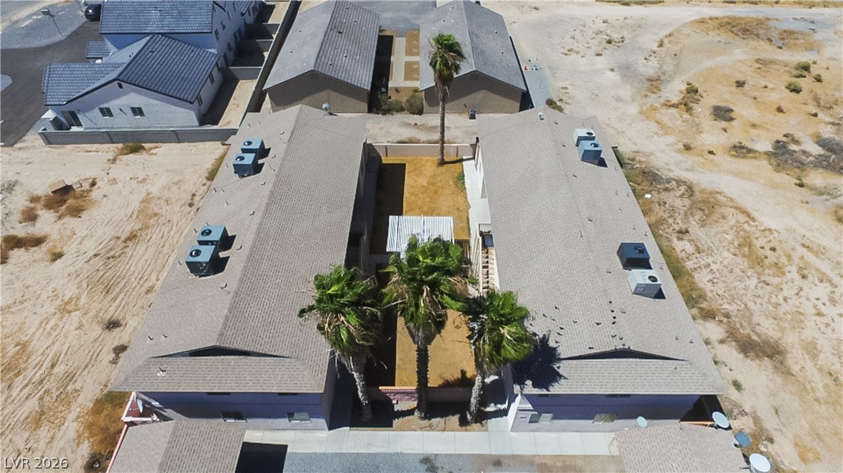 1444 Star Road Pahrump, NV 89048 - Photo 31 of 37 An aerial perspective reveals the architectural layout and shingle roofing of these multi-unit residential structures.