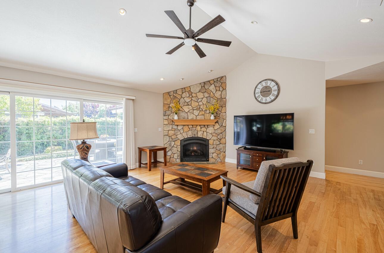 22470 Estoque Place Salinas, CA 93908 - Photo 8 of 45 a living room with furniture a flat screen tv and a fireplace